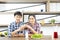 Young Asian lovely couple drinking coffee with milk in kitchen at home, married people lifestyle