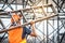 Young Asian maintenance worker carrying aluminium ladder