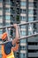 Young Asian maintenance worker carrying aluminium ladder