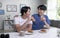 Young Asian male couple lifestyle living concept. Happy LGBT gay couple having breakfast together in the kitchen