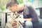 Young Asian male dog owner hugging and embracing the Husky Siberian dog pet with love and care