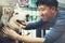 Young Asian male dog owner playing and touching the happy Husky Siberian dog pet with love and care.