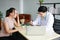 Young Asian male psychiatrist is specialist in psychiatry Caucasain female Patient serious together for therapy and talking for
