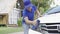 Young Asian male staff cleaning cars outside the property excellent He was wiping the headlights of a white car. Workers washing c