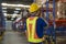 Young asian male worker wearing helmet using talki walki in modern warehouse