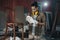 Young Asian man Carpenter uses a tape measure to measure chair on the workbench in woodcraft carpentry workshop.