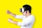 Young asian man in casual outfit holding or wearing VR glasses goggles playing car racing video game