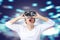Young asian man in casual white wearing and holding VR glasses by hands looking up above feeling excited and amazed