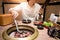 Young Asian man eating Korean Barbecue buffet in restaurant