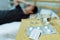 Young Asian man feeling sick and ill lying on bed with medicines tablets and pills on table