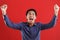 Young asian man happy and excited expressing winning gesture. Successful and celebrating