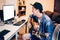 Young Asian man learning how to play guitar on computer monitor. Male guitarist watching online tutorial. Include clipping path