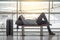 Young Asian man lying on bench in airport terminal