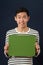 Young Asian man showing green copy space box