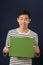 Young Asian man showing green copy space box