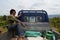 Young asian man sitting in small truck