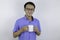 Young asian man is smile and bring white mug of coffee to enjoy it in morning.