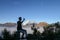 Young asian man taking a picture of beautiful mountains landscape in Bromo Mountain National Park, East Java, Indonesia