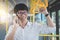 Young Asian man traveler standing on a bus talking and using smartphone while smile of happy, transport, tourism and road trip co