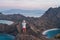 Young Asian man traveller standing and taking picture on top of Padar island in a morning sunrise, Komodo national park in Flores