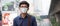 Young Asian man wearing N95 respiratory mask protect and filter pm2.5 particulate matter against traffic and dust city.