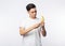 Young asian man in white t-shirt peeling banana with happy face isolated on white background.