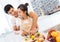 Young Asian man and woman couple together cutting slice vegetables