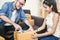 Young asian man and woman taping up a cardboard box in the office SME business