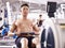 Young asian man working out using rowing machine