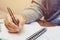 Young asian man writing form filling with register on paper note