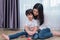 Young Asian mom and son playing toy in house. Mother and son concept. Happy family and Home sweet home theme. Preschool and Back