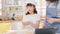 Young Asian mother and daughter wear apron learn making food using digital tablet in home kitchen