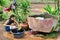 Young Asian mother washes dishes in primitive kitchen.