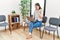 Young asian nurse woman sitting at waiting room using laptop celebrating victory with happy smile and winner expression with