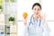 Young asian nutritionist recommend eating orange and ok sign