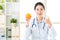Young asian nutritionist recommend eating orange and thumbs up