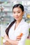 young asian pharmacist holding container with medication and smiling at camera