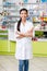 young asian pharmacist with medication smiling at camera