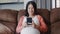 Young Asian Pregnant woman using mobile phone search pregnancy information.