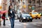 Young Asian professional woman walking home commuting from work in New York city street. Urban people lifestyle commuter