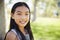 Young Asian schoolgirl smiling to camera, close up