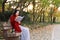 Young asian sensual woman reading a book in romantic autumn scenery.Portrait of pretty young girl in autumnal forest