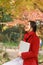 Young asian sensual woman reading a book in romantic autumn scenery.Portrait of pretty young girl in autumnal forest