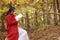 Young asian sensual woman reading a book in romantic autumn scenery.Portrait of pretty young girl in autumnal forest