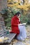 Young asian sensual woman reading a book sit bench in romantic autumn scenery.Portrait of pretty young girl in autumnal forest