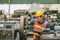 Young Asian Technician Engineer Staff Worker using Lathe CNC Milling Machine work in Heavy Metal Factory