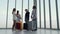 Young Asian teens are having fun while waiting for a flight inside the airport lounge building.