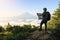 Young Asian tourist trekking to the top and checking map