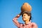 Young Asian traditional farmer carrying clay pot on head