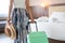 Young Asian traveler woman with green luggage and straw hat in hotel room after check-in. Travel and summer holiday concept